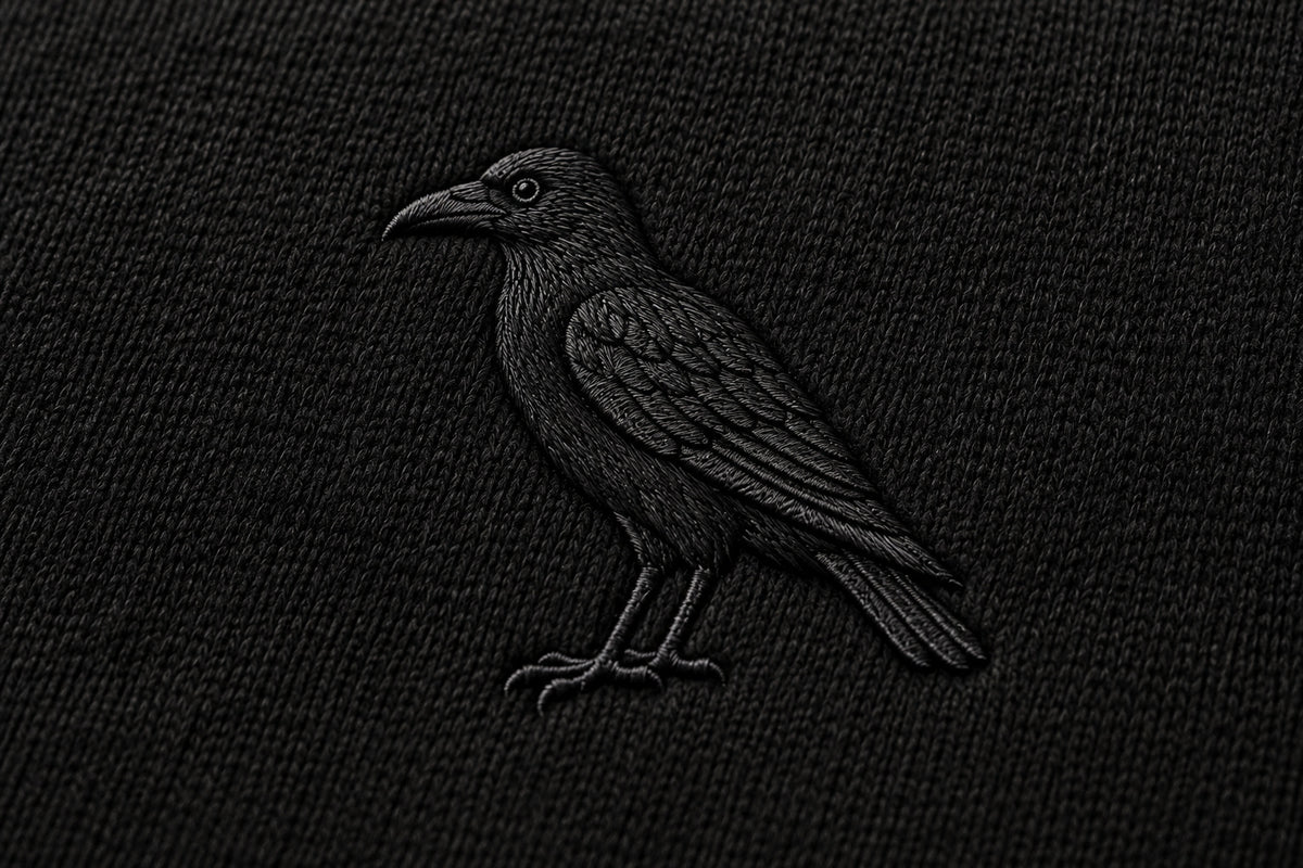 Raven embroidery detail on the Night Flight Hoodie